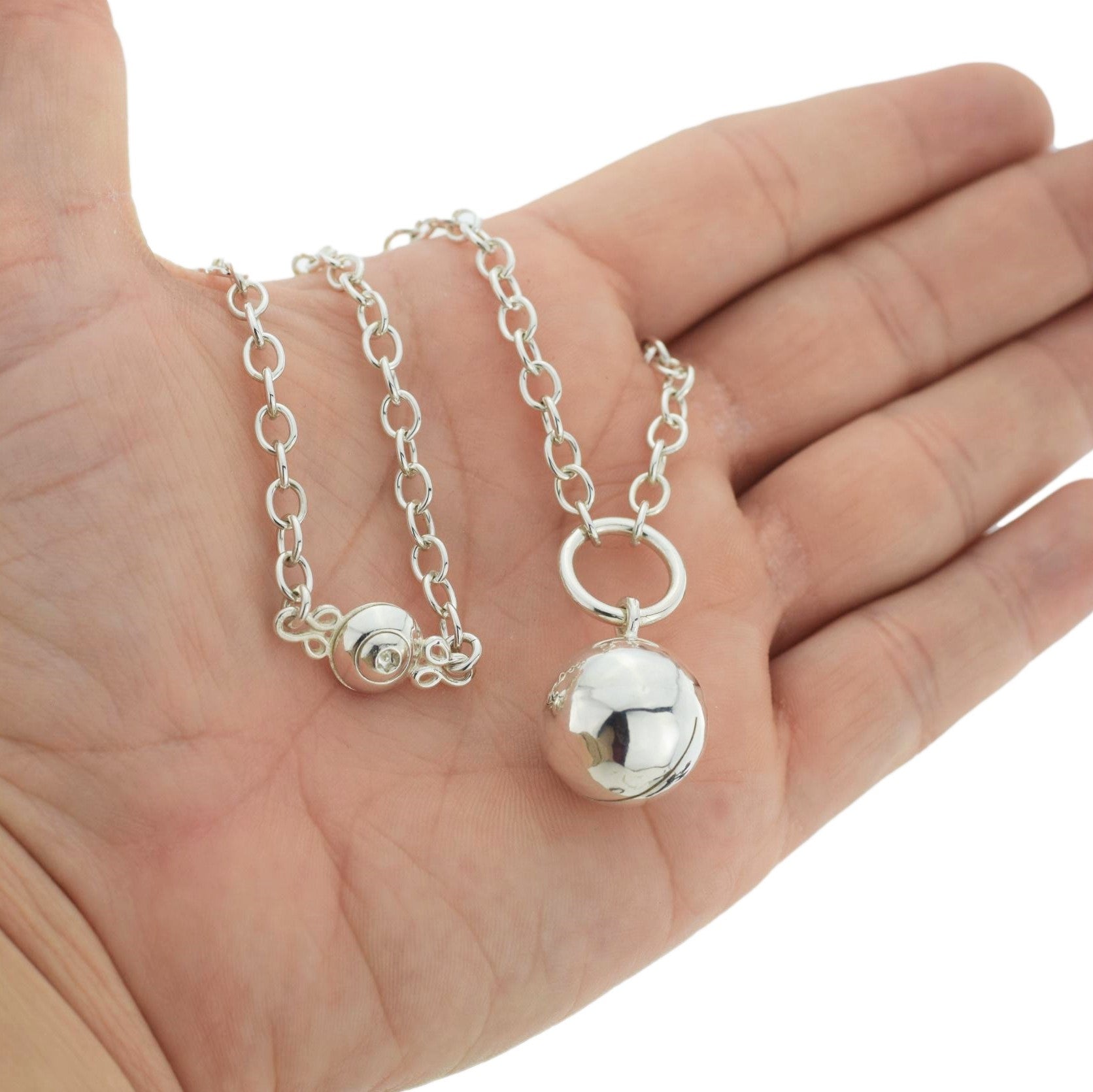 BDSM Locking Day Collar Jewelry Necklace of Lock and O ring with large sterling bell available in solid 316L Stainless Steel or 925 sterling silver shown on a model's hand