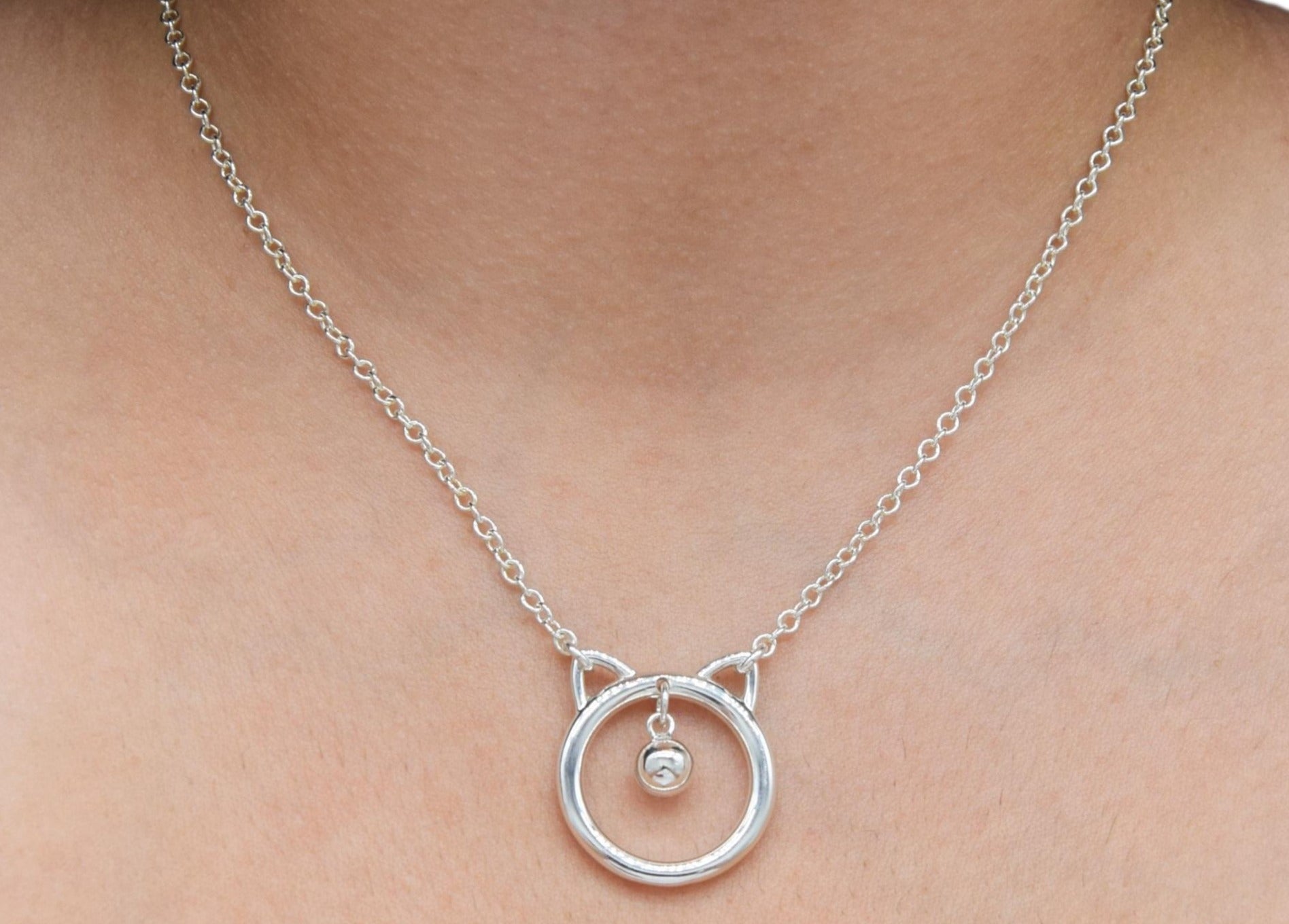 BDSM Locking Day Collar Jewelry Necklace of Lock and O ring with large sterling bell available in solid 316L Stainless Steel or 925 sterling silver shown on a model's neck