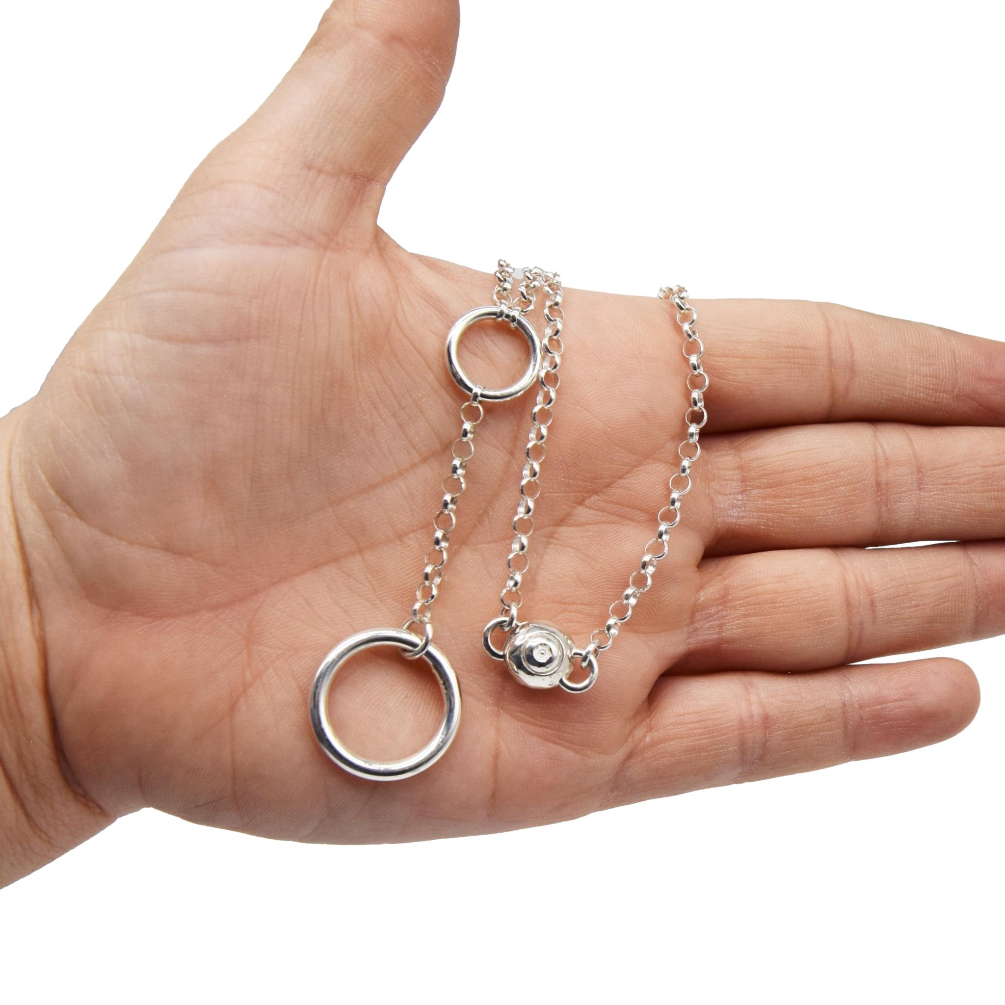 BDSM Locking Day Collar Jewelry Necklace of Lock and O ring available in solid 316L Stainless Steel or 925 sterling silver shown on a model's hand