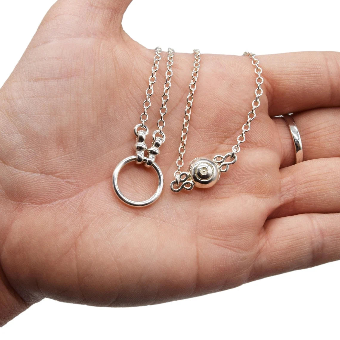 BDSM Locking Day Collar Jewelry Necklace of Lock and O ring available in solid 316L Stainless Steel or 925 sterling silver with new fancy ends shown on a model's hand