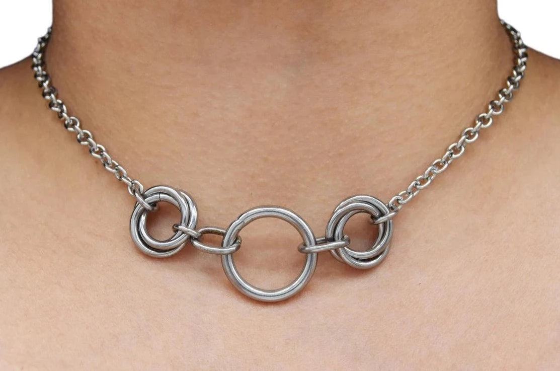 BDSM Locking Day Collar Jewelry Necklace of Lock and O ring with large sterling bell available in solid 316L Stainless Steel or 925 sterling silver shown on a model's neck