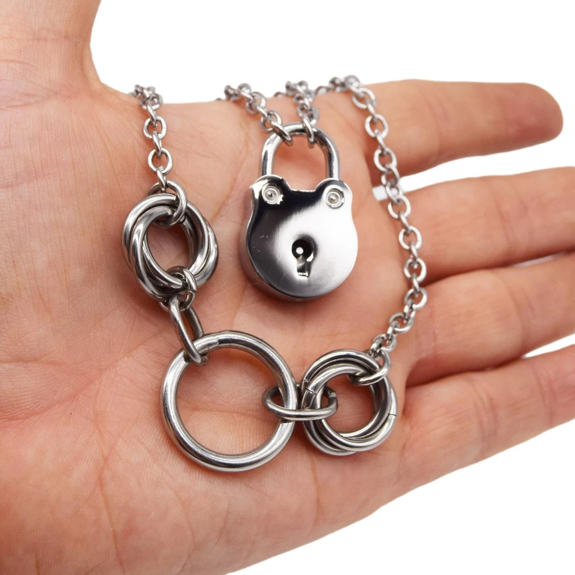 BDSM Locking Day Collar Jewelry Necklace of Lock and O ring with large sterling bell available in solid 316L Stainless Steel or 925 sterling silver shown on a model's hand
