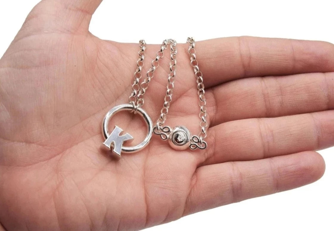 BDSM Locking Day Collar Jewelry Necklace of Lock and O ring BDSM Locking Day Collar Jewelry Necklace of Lock and O ring available in solid 316L Stainless Steel or 925 sterling silver shown on a model's neck available in solid 316L Stainless Steel or 925 sterling silver shown on a model's hand