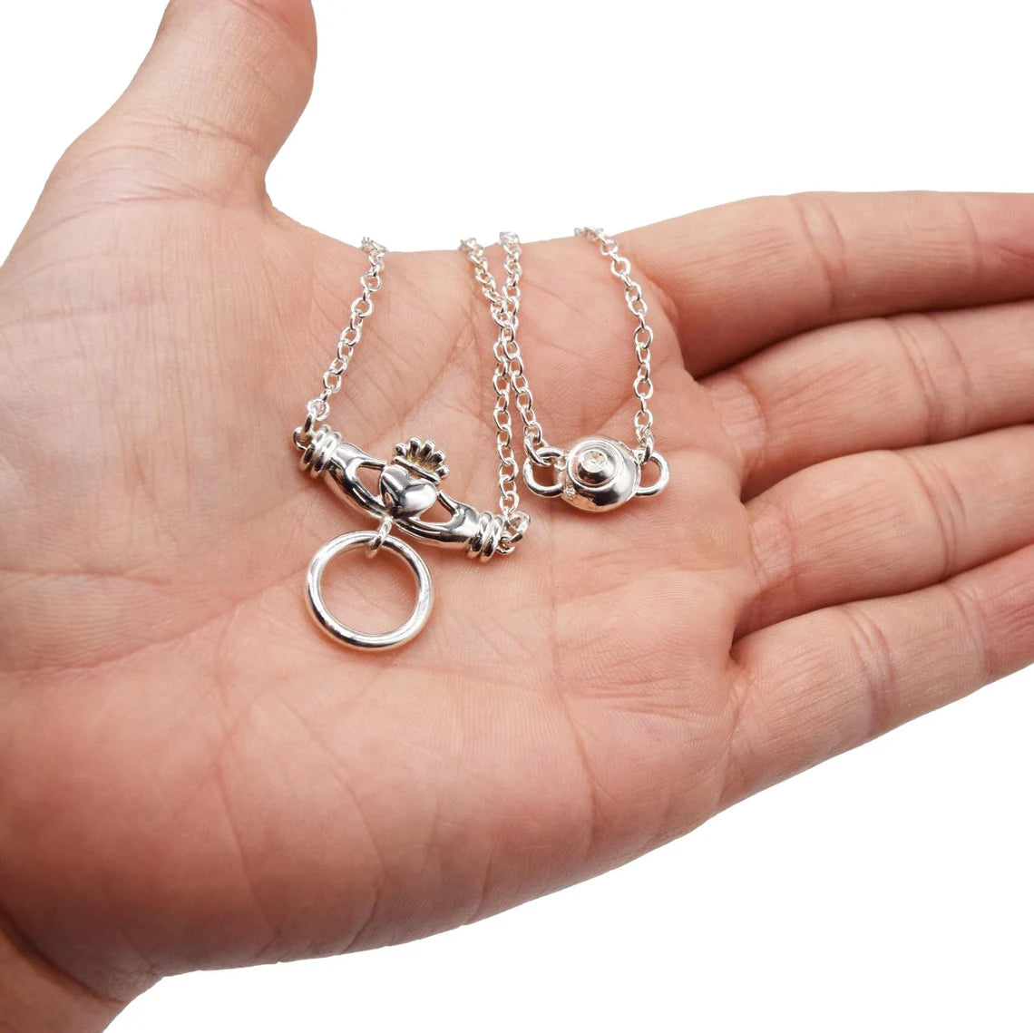 BDSM Locking Day Collar Jewelry Necklace of Lock and O ring Celtic Claddagh available in solid 316L Stainless Steel or 925 sterling silver shown on a model's hand