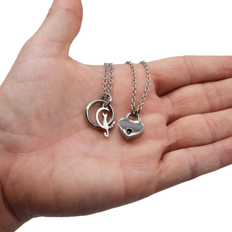 BDSM Locking Day Collar Jewelry Necklace of Lock and O ring with large sterling bell available in solid 316L Stainless Steel or 925 sterling silver shown on a model's hand