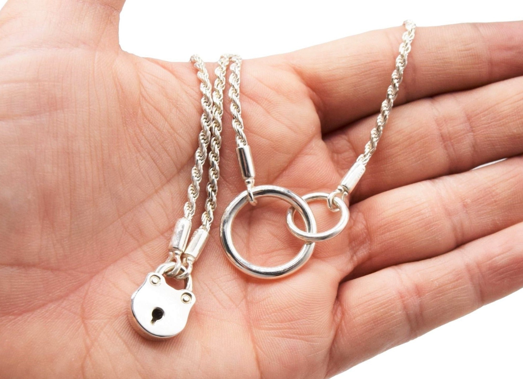 BDSM Locking Day Collar Jewelry Necklace of Lock and O ring with large sterling bell available in solid 316L Stainless Steel or 925 sterling silver shown on a model's hand