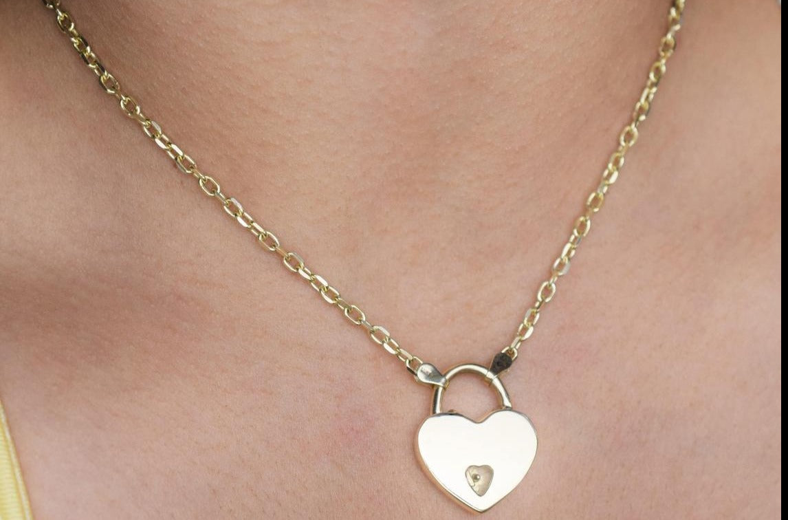 BDSM Submissive Day Collar  made of sculpted Oval links in Solid 14K Gold shown with one of our world Famous Mini Heart Padlock locks that are functional and made of the finest precious metals on a model's neck