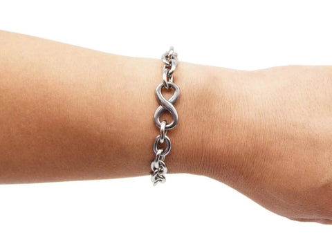 BDSM Locking Day Collar Jewelry wrist bracelet of Lock and O ring with large sterling bell available in solid 316L Stainless Steel or 925 sterling silver shown on a model's arm